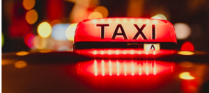 A red taxi sign above a cab.